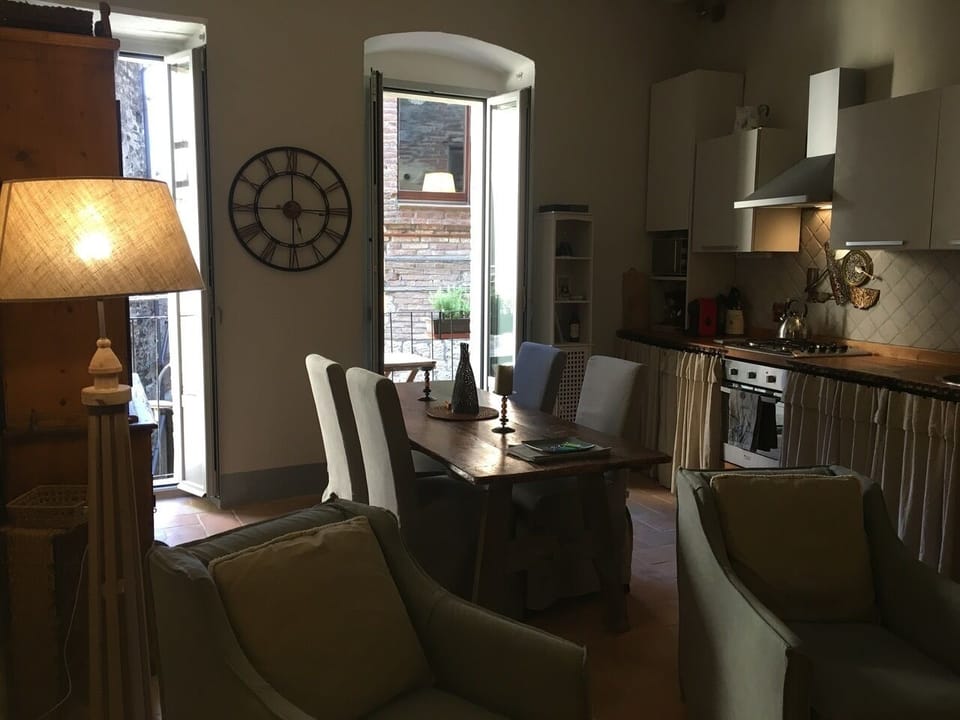 Kitchen, dining area looking out to small, sunny balcony