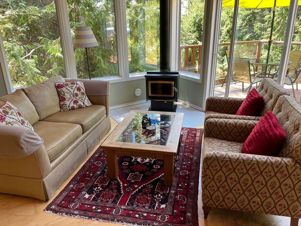 bright living room with wood burning fireplace
