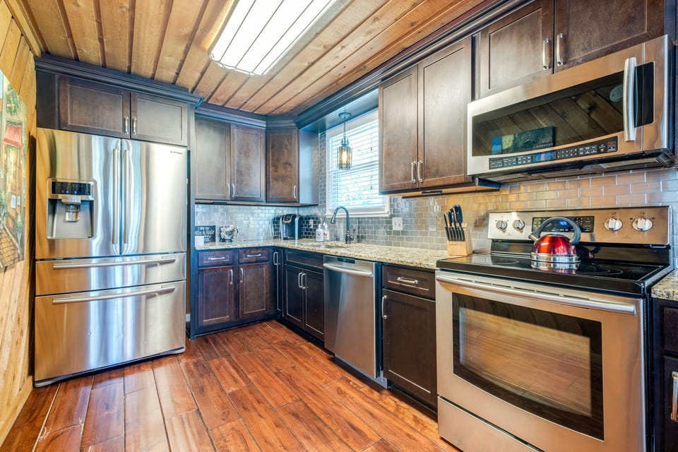 A kitchen meant to be used. Updated appliances, generous counter space, and a thoughtfully stocked collection of dishes, cookware, and serving pieces make dining in effortless.