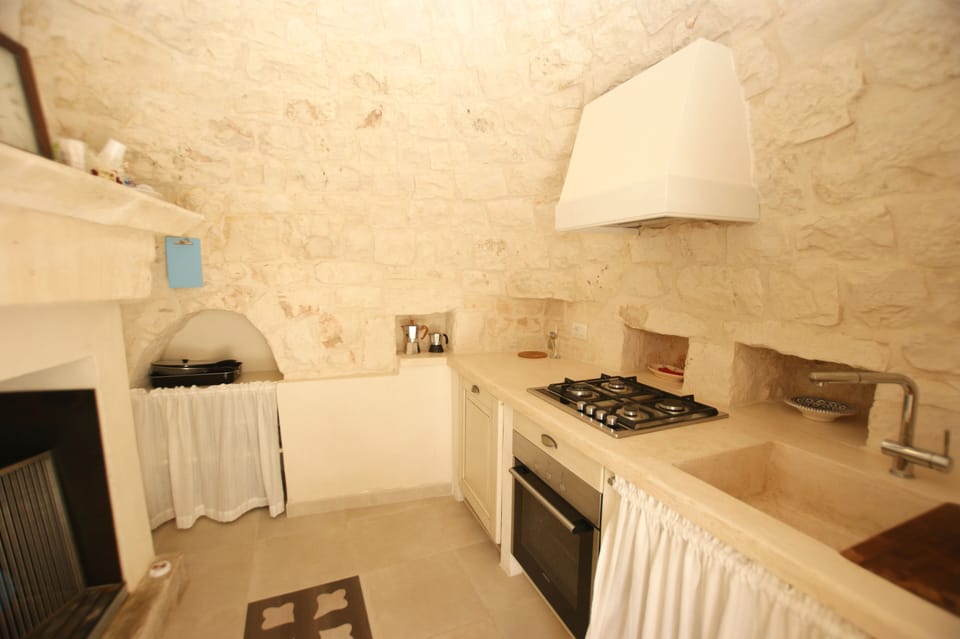 The "outdoor kitchen" is in a separate trullo next to the terrace.
