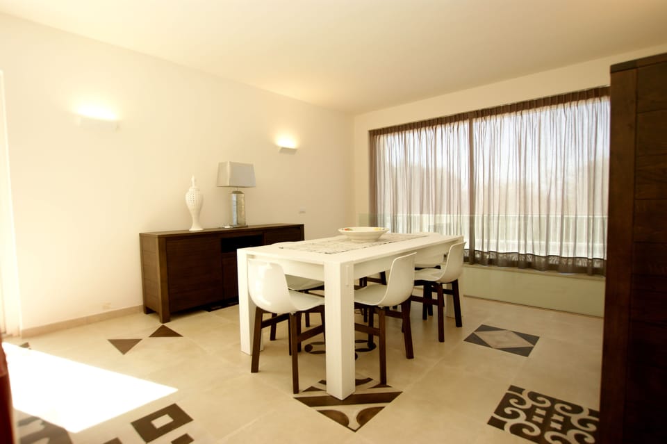 In the back part of the dining area there is a staircase down to the garage.