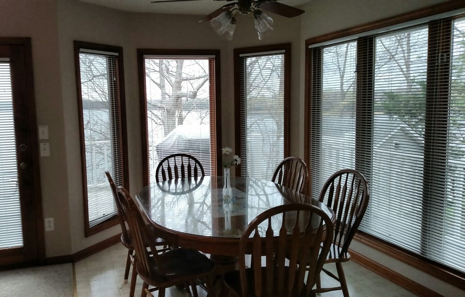 Dining with bay windows and panoramic lake views.