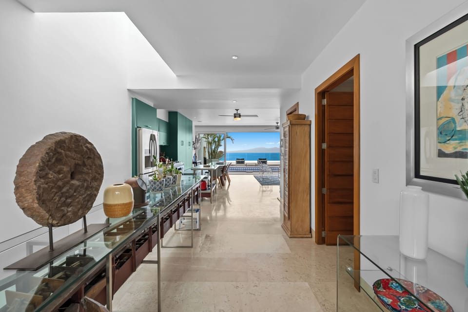 Antique filled upper level living room open to terrace with panoramic ocean view