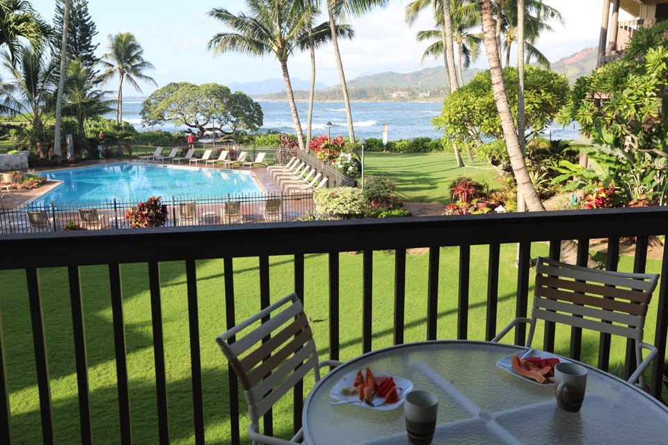 View of ocean, pool and landscaped grounds from lanai