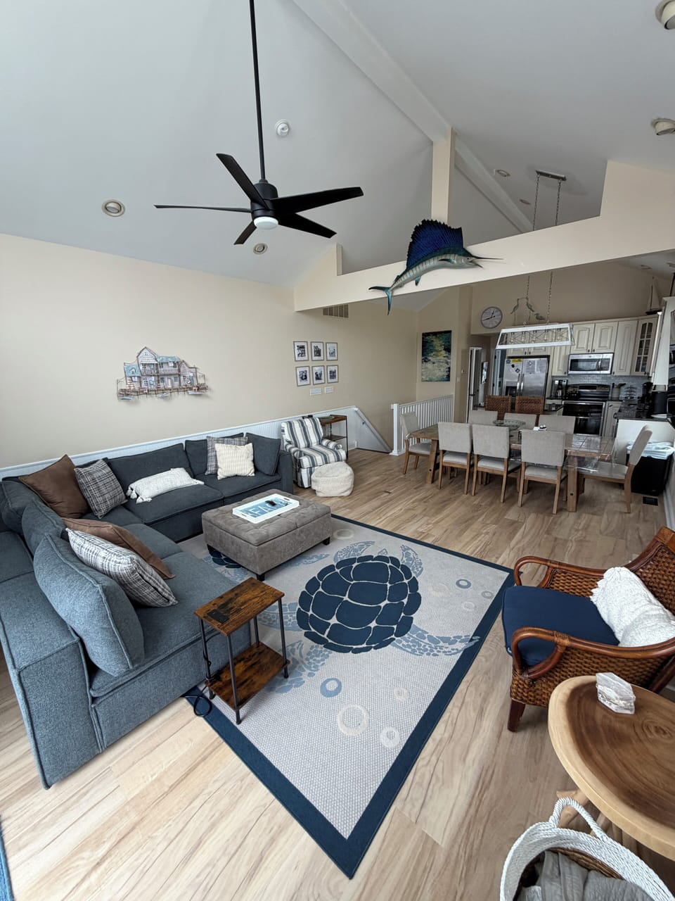 Great room with a new dining room table and sectional sofa. 