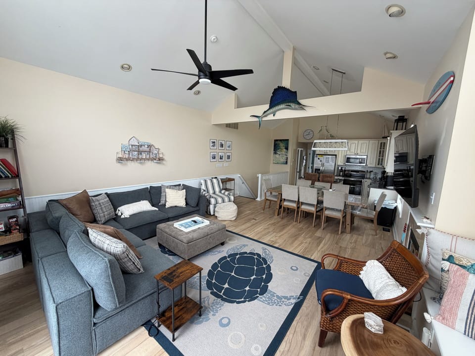 Great room with a new dining room table and sectional sofa. 
