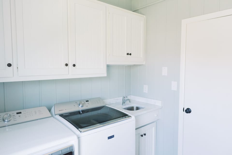 Large laundry room with drying rack.