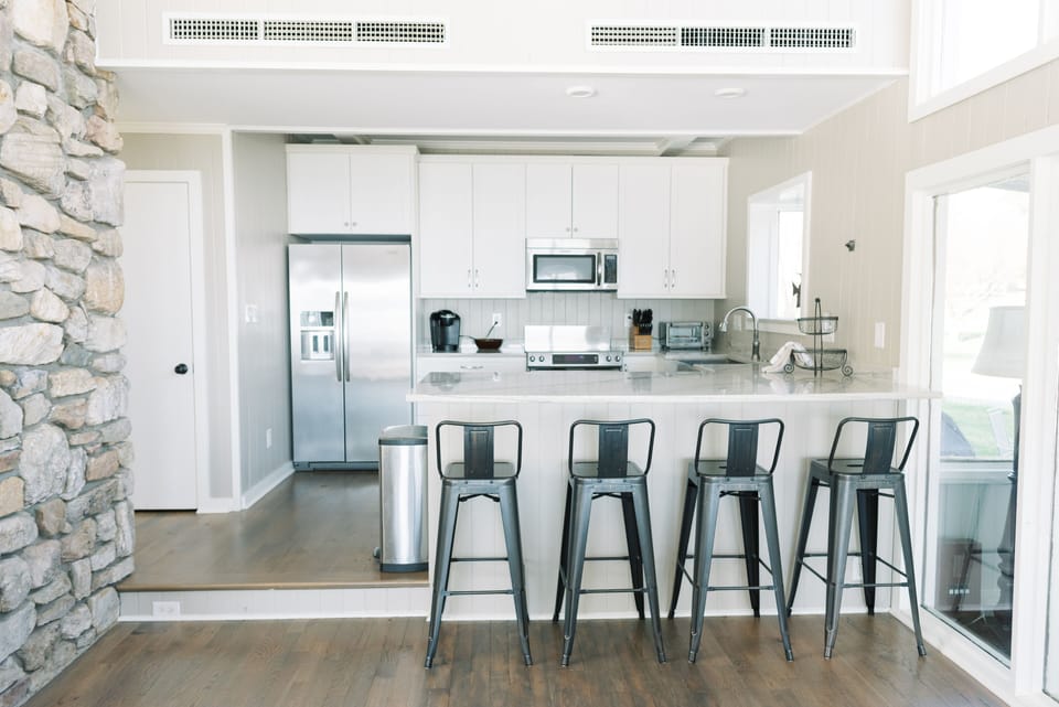 Kitchen includes bar with seating.