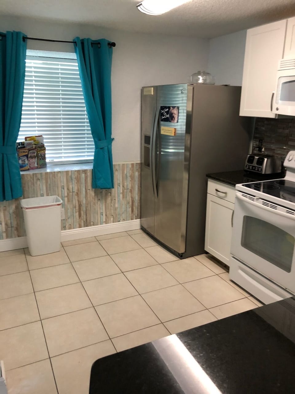 Side by Side Fridge includes Ice Maker. 
Flat Top Stove, Built-in Microwave.