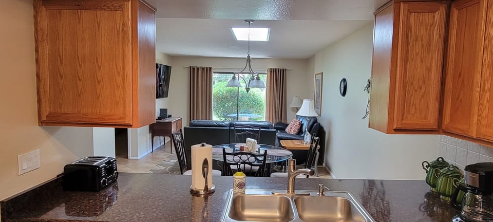 Kitchen fully equipped overlooks eating area and living room