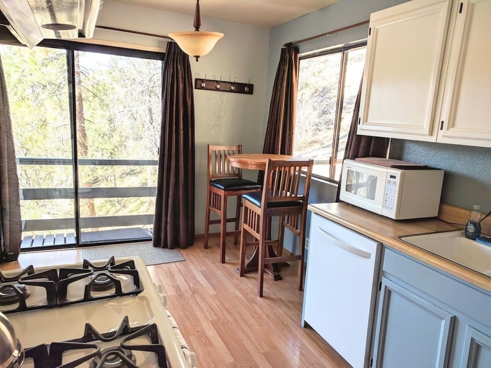 Kitchen - Cafe table w/ 2 chairs and slider going out to the backyard.