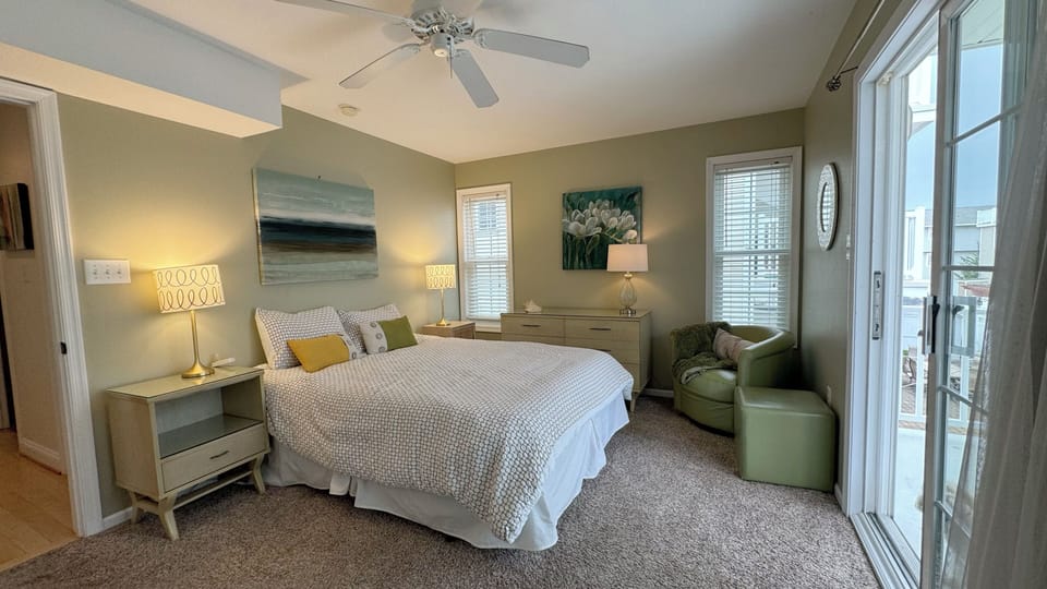 Queen bedroom #1 has a private deck facing the backyard and a bay view.