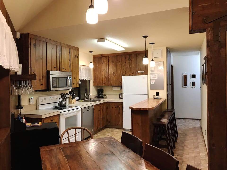 Open kitchen with adjacent counter creates a culinary and social atmosphere.