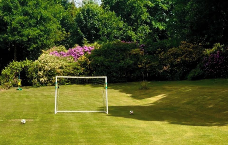 Football posts, badminton and swingball are available in the garden.