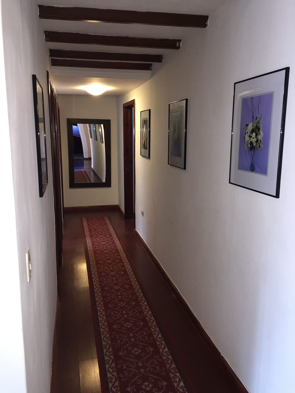 Hall way leading to 3 bedrooms and 2 full baths