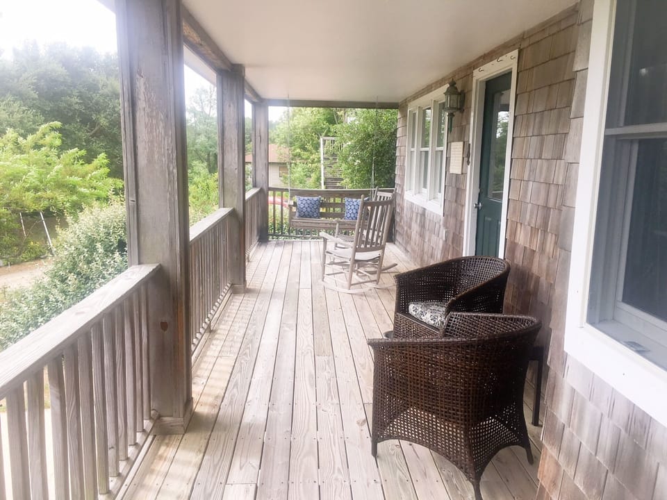 Covered porch with porch swing and rocking chairs