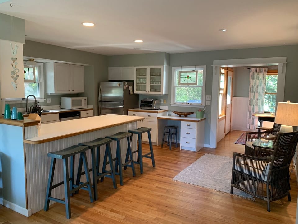 Kitchen with seating area and 4 bar stools