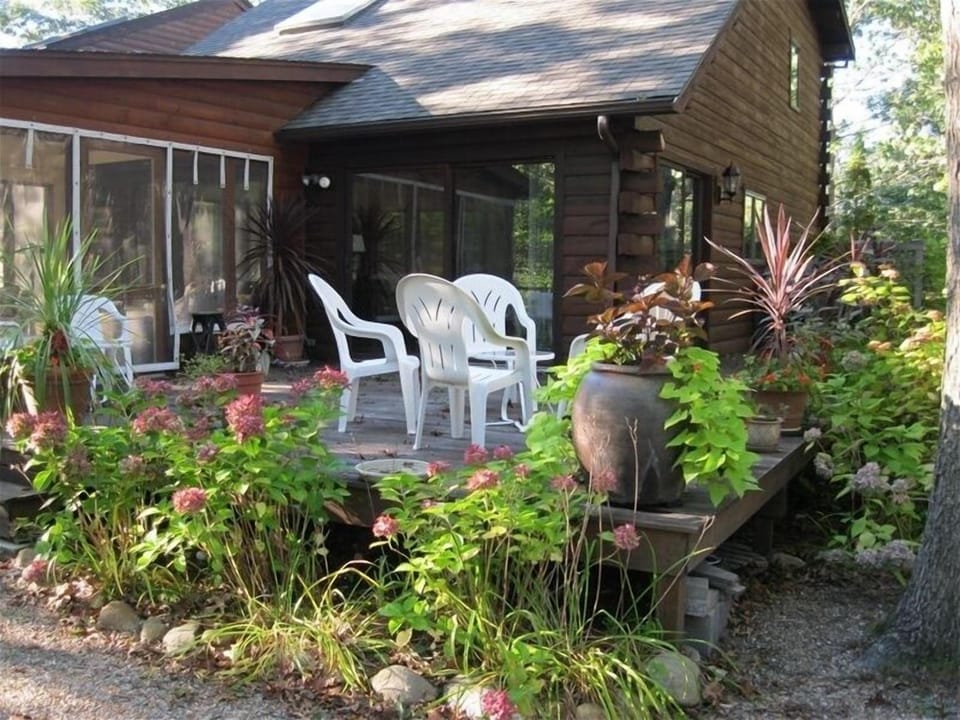 Sunroom accesses deck. Ample seating on outside deck.  gas grill on side deck