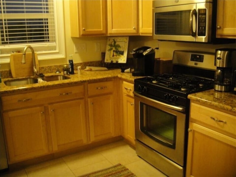 Full kitchen with stainless appliances and gas stove
