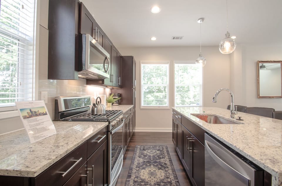 Kitchen with stainless steel appliances. Basics include plates, cups, and coffee