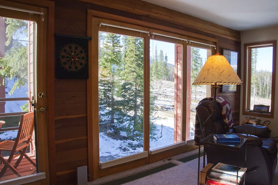 LR Wall of Windows with Door to Private Deck. Forest & Mt Views