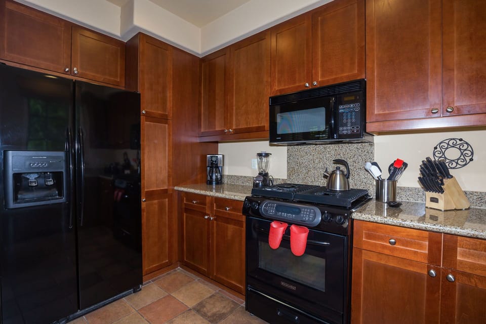 Cooks Kitchen with high-end appliances and granite countertops