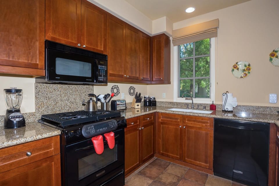 Cooks Kitchen with high-end appliances and granite countertops