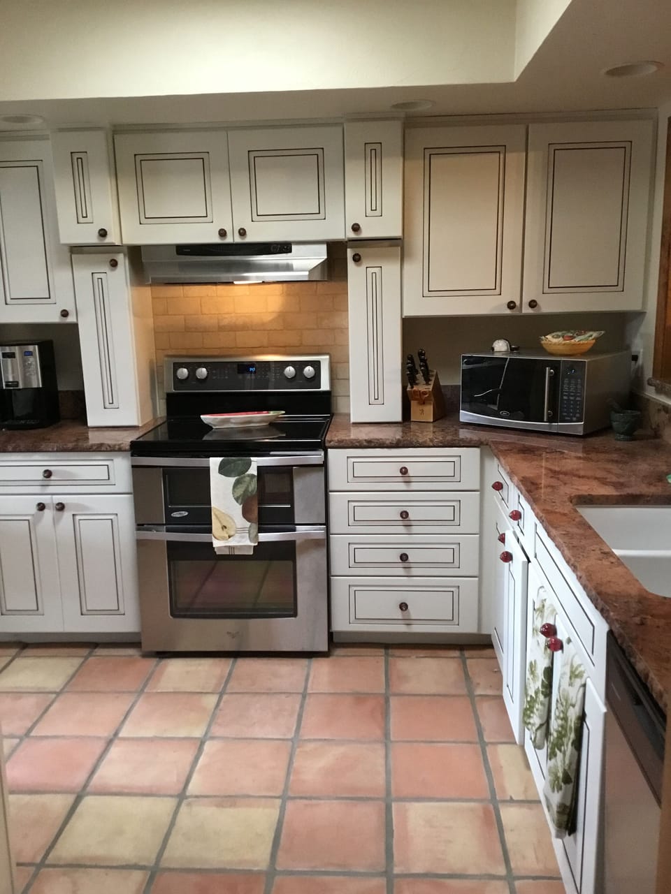 Kitchen comes with appliances, pots, pans and dishes .