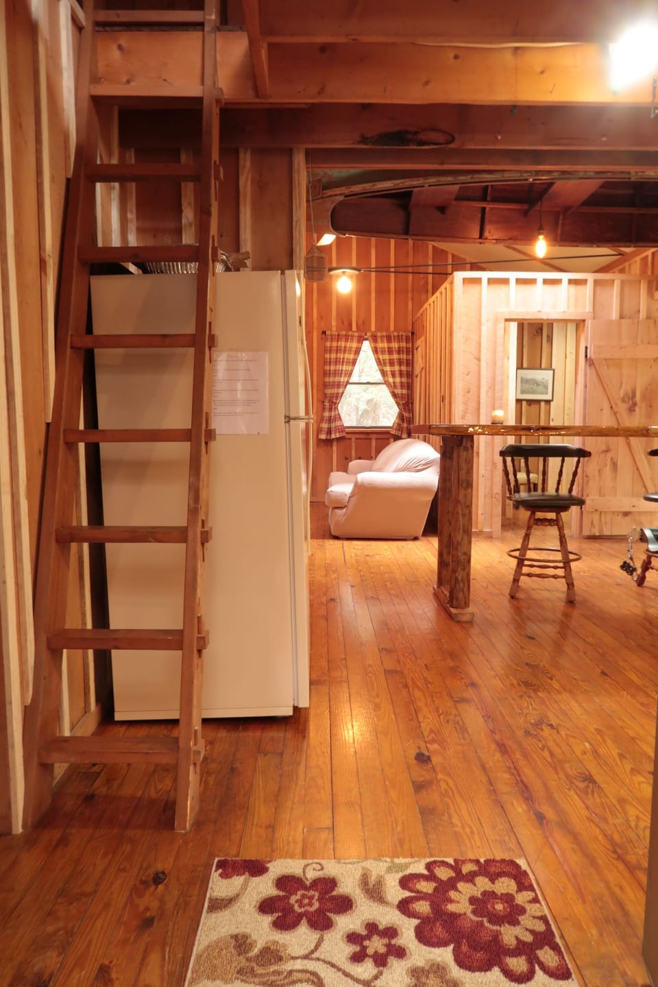 First view walking into cabin. The ladder gives access to the loft above kitchen