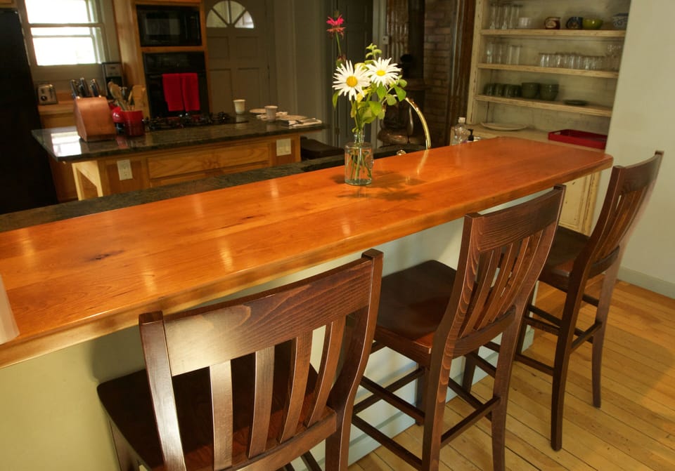  kitchen bar area with pot belly wood stove in background.