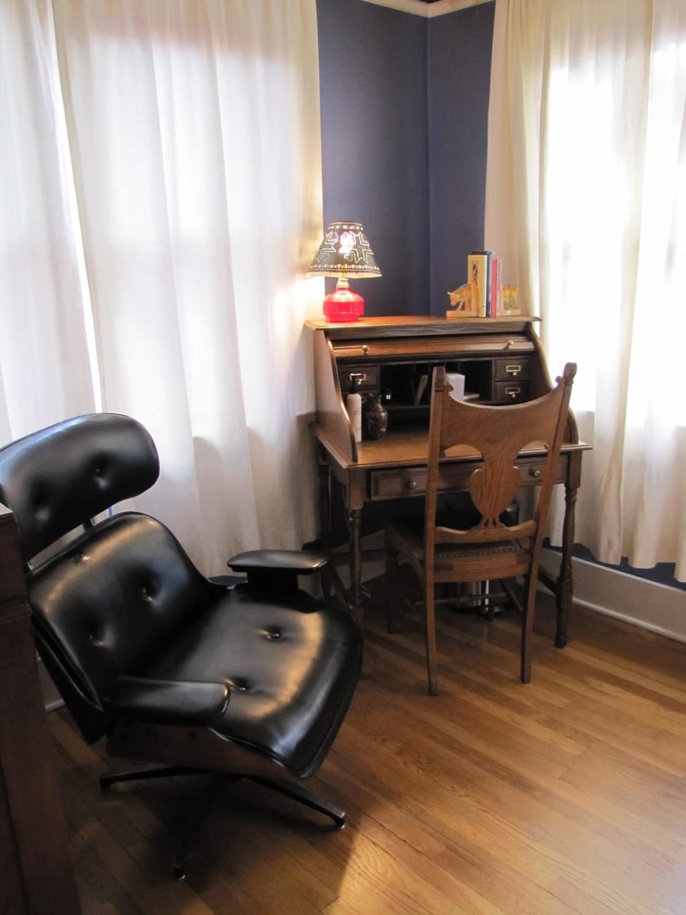 Office area with writing desk and reading chair.