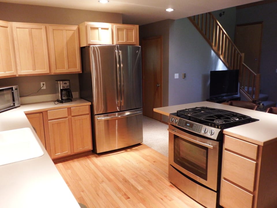 Kitchen with new stainless steel appliances and gas cooktop