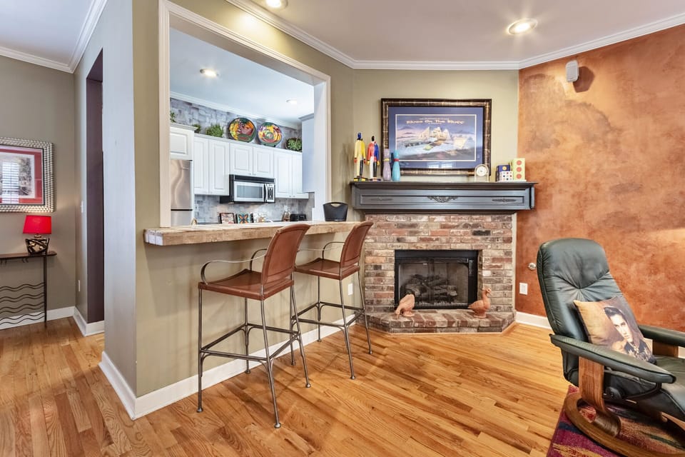 Gas fireplace in living area looking through bar into kitchen
