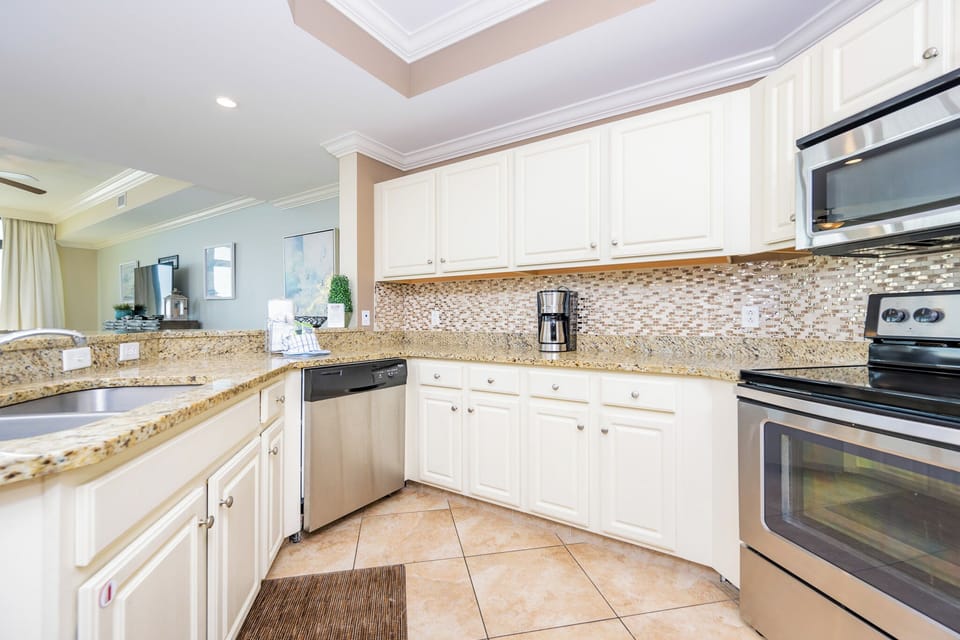 The kitchen features stainless appliances, granite countertops, and a breakfast bar for family meals and entertaining