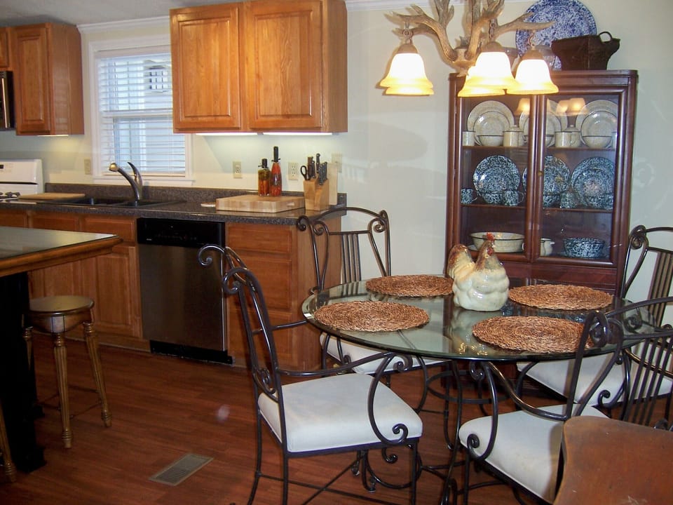 Kitchen and dining area; the dinette sits 4, island sits 4, and front porch table sits 4.