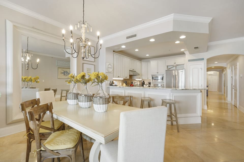 The whole family can dine after preparing delicious meals in the bright open concept kitchen and dining room with white cabinetry and modern finishes