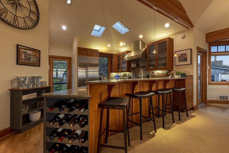 Chef's kitchen with professional grade appliances and bar seating for 4