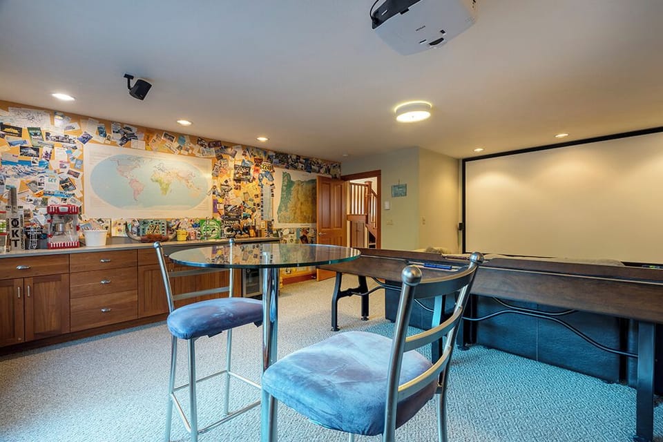Game/Theater room with 150" projection screen, shuffleboard table, wet bar