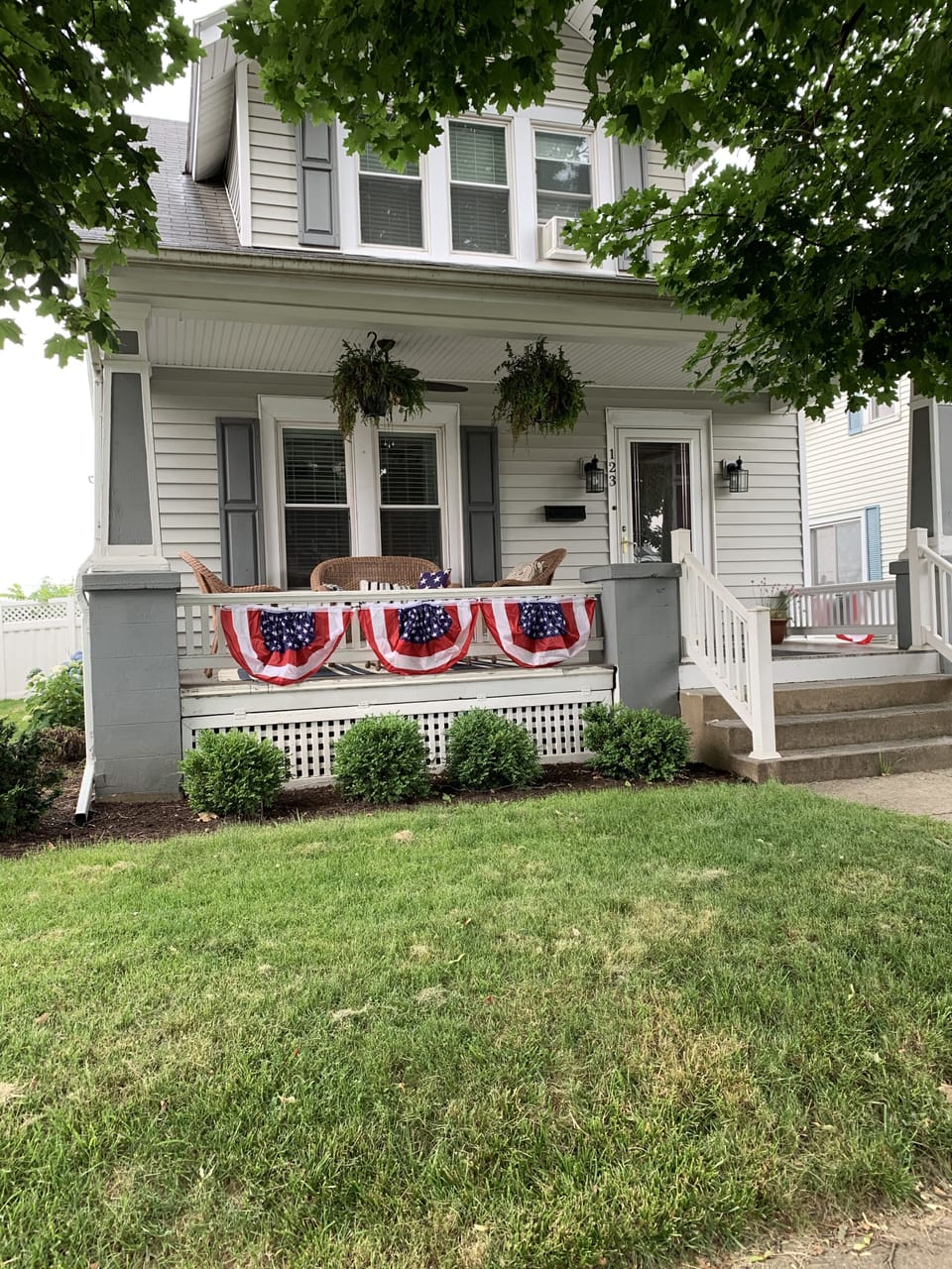 Quiet front porch on a tree lined street for your morning coffee.