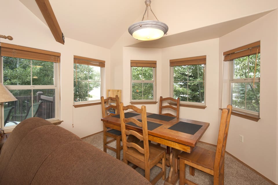 Dining room off of living area and kitchen with seating for 4 people.