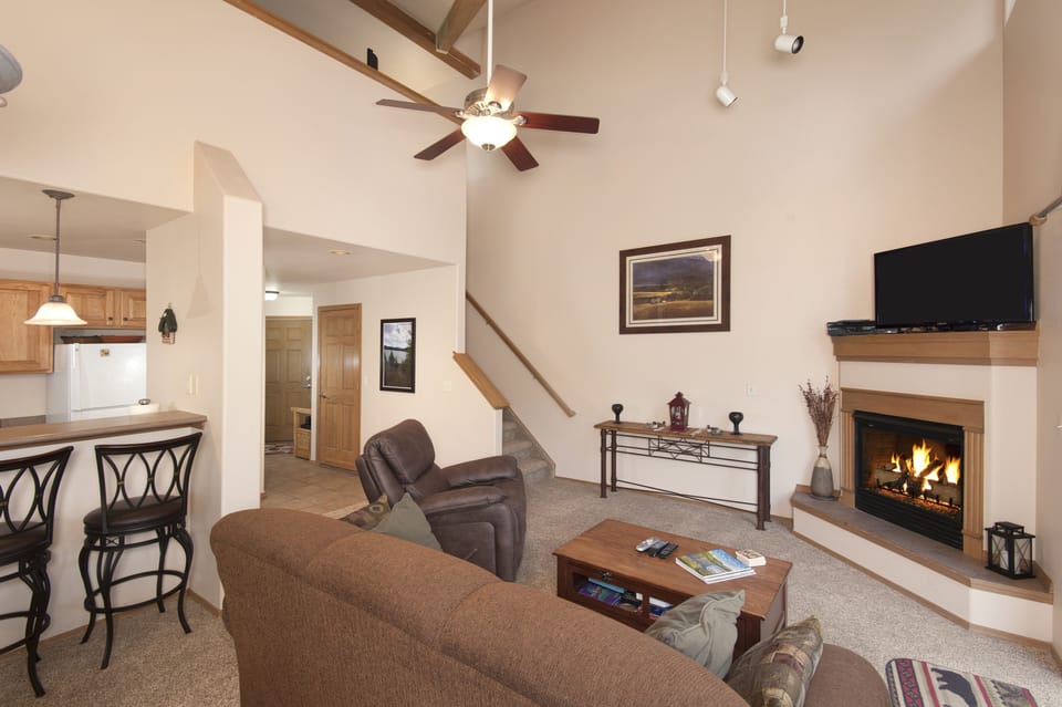 Main level living area with smart TV and gas fireplace.