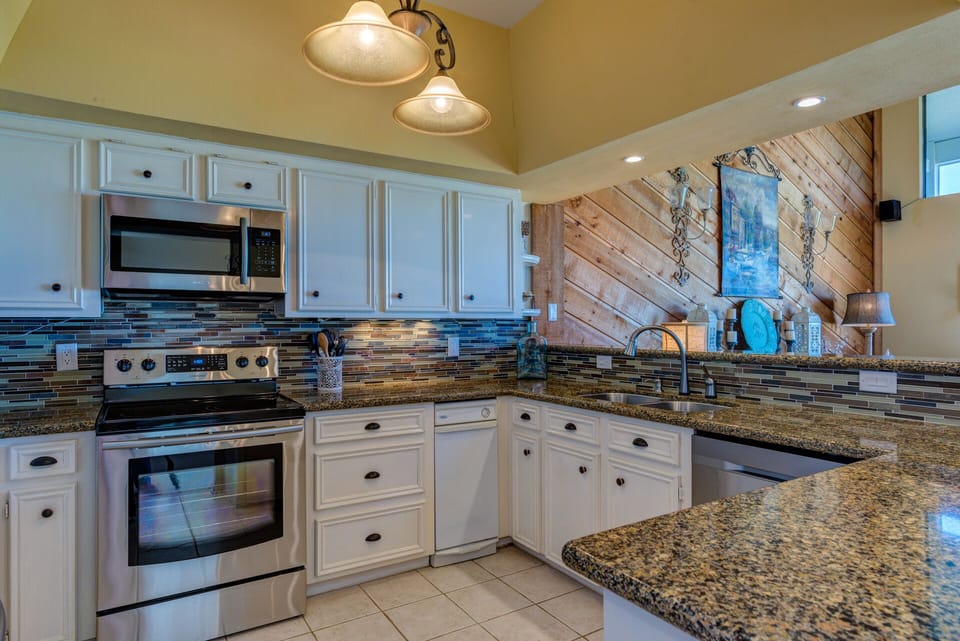 Spacious kitchen with new stainless steel appliances - fully stocked with basics