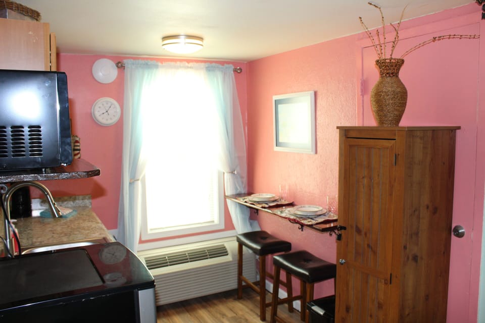 Beautiful  new kitchen in coral, mint & navy tones w/ wrought iron accents.