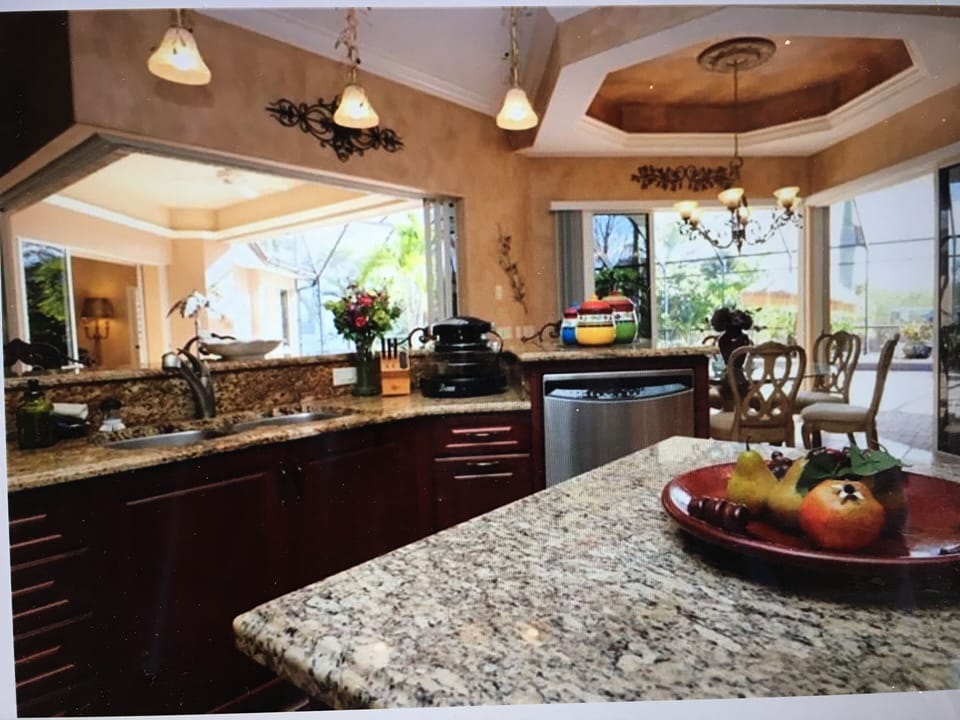 gorgeous granite countertops, with center island and tray ceilings with designer