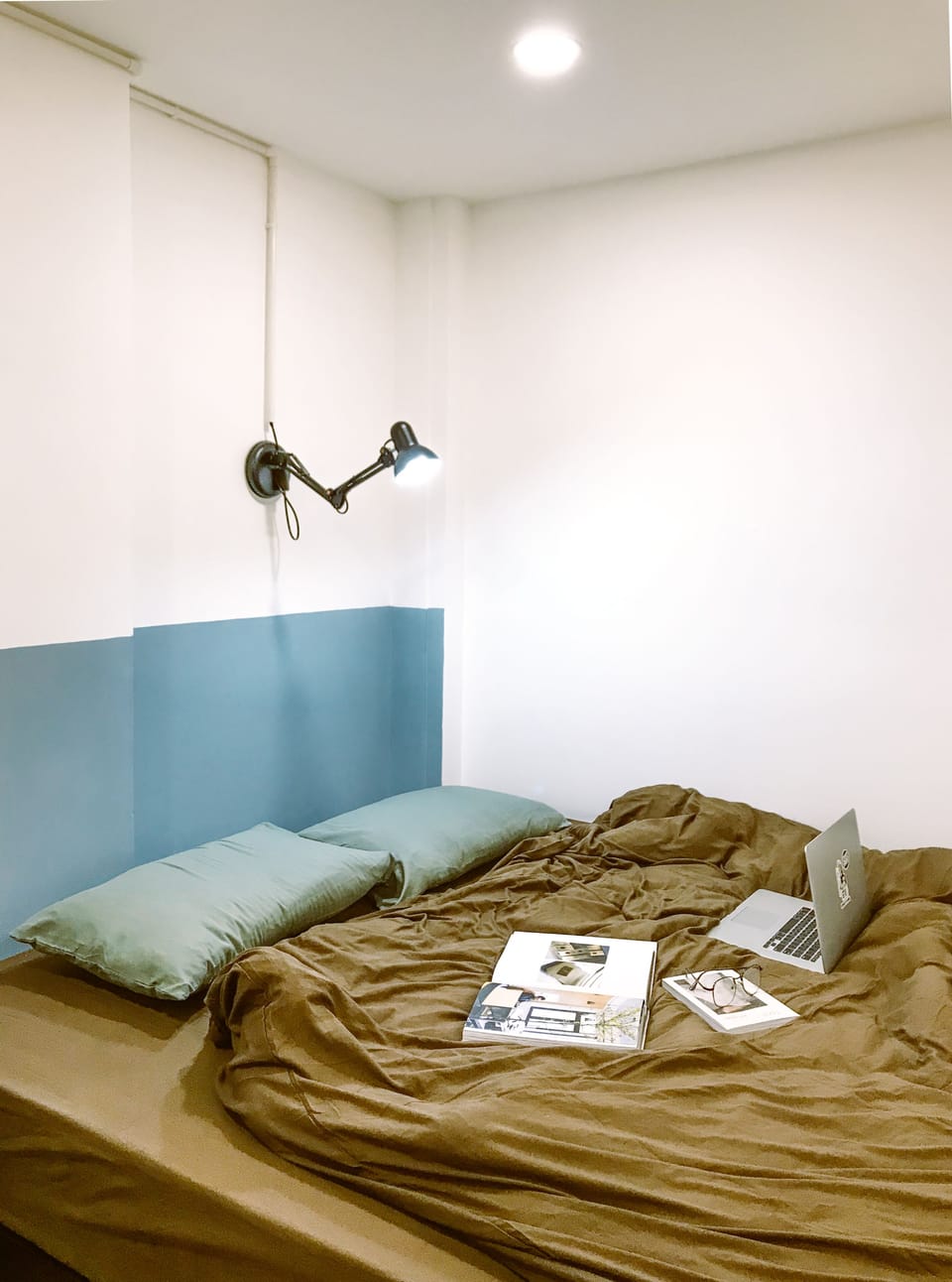 A comfortable king bed being subtly arranged in the common space