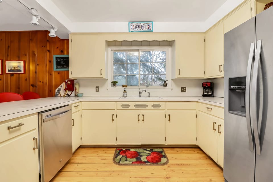 New stainless steel appliances including dishwasher.