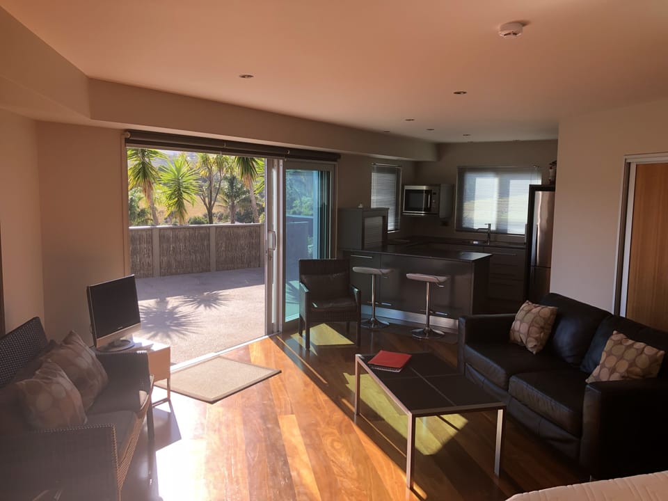 Inside studio with the kitchen area in background