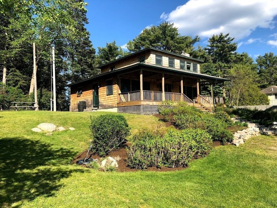 View of cottage and lawn