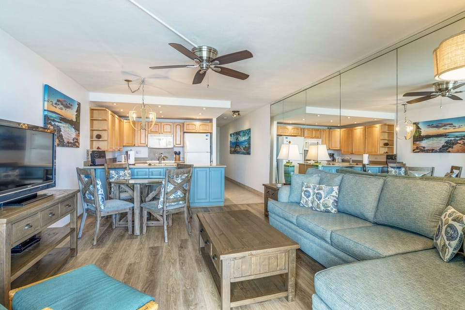 The living room features plenty of seating, a desk area, cable TV, and a Queen size sleeper sofa