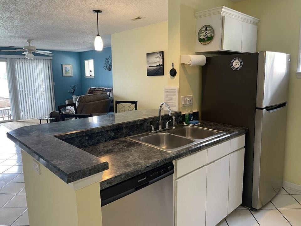 Full kitchen with stove, oven, microwave, pots, pans, dishes and utensils. 